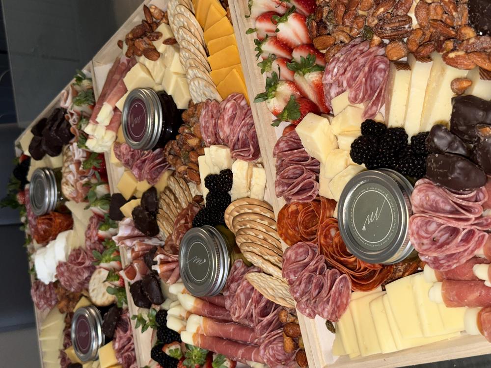 A lineup of freshly prepared Miora Cheese boards for a catering order