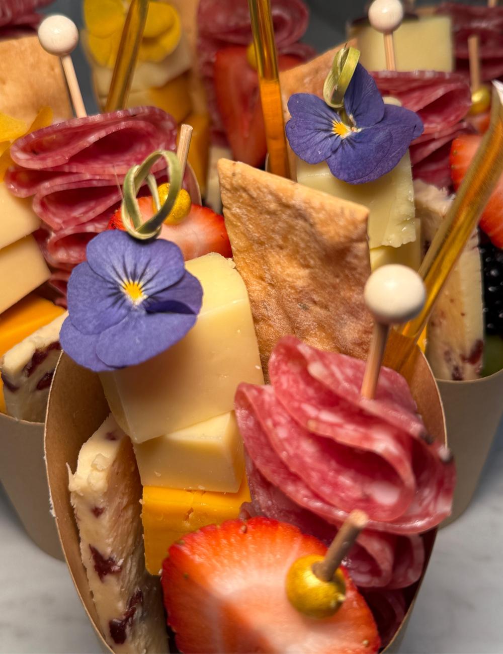 Charcuterie cup with salami rose, artisan cheese and edible flower, styled by hand