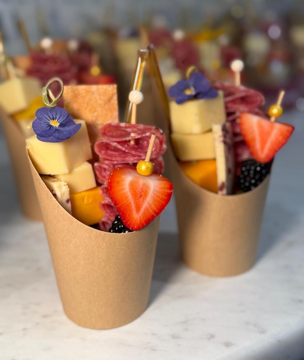 Individual charcuterie cups with cheese, salami and fresh fruit, ideal for yacht service